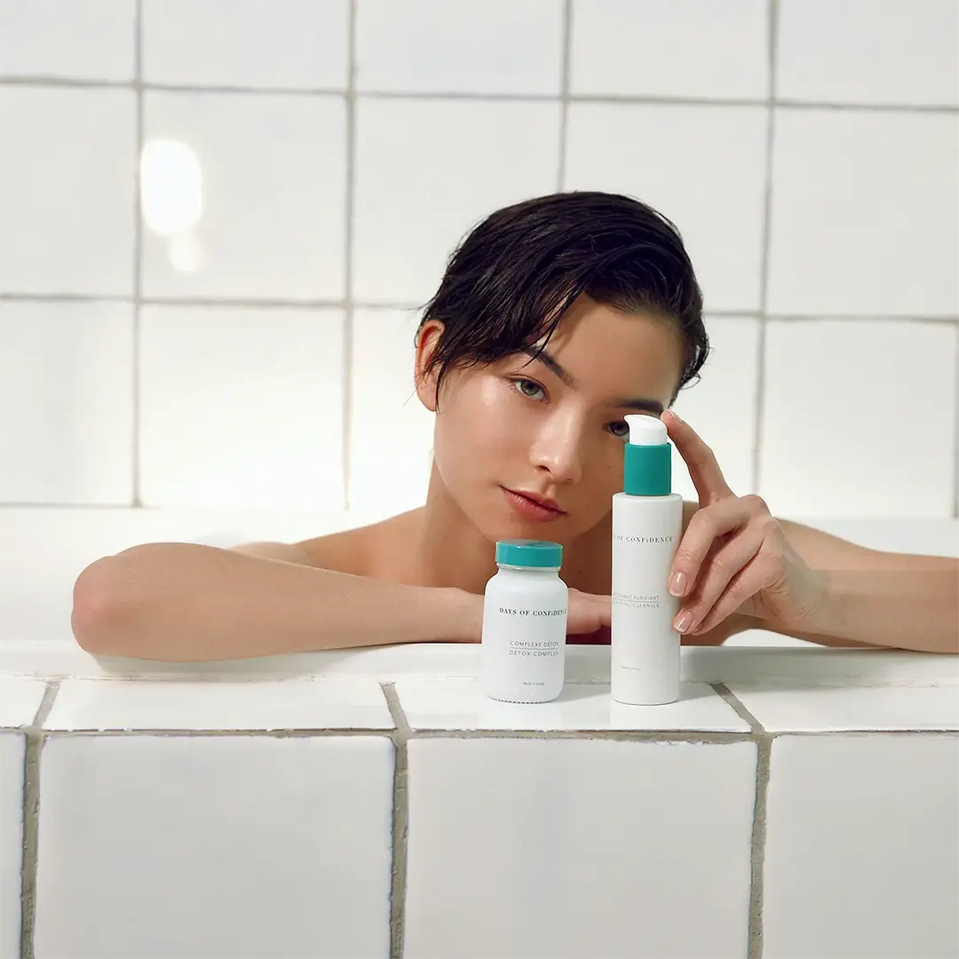 fille peau blanche origine européenne et asiatique dans une baignoire avec produits days of confidence suppléments détox et nettoyant purifiant visage